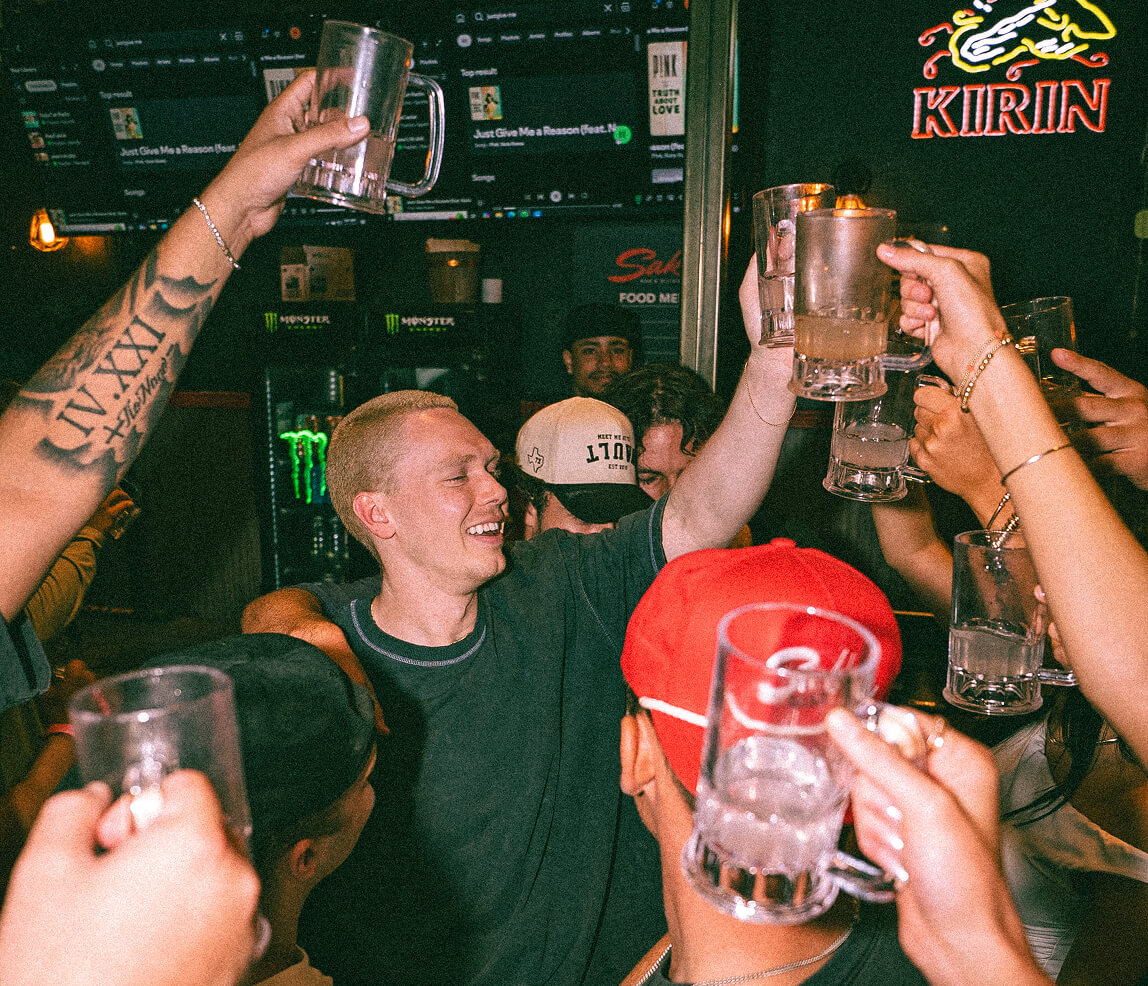 A group cheers at Sake