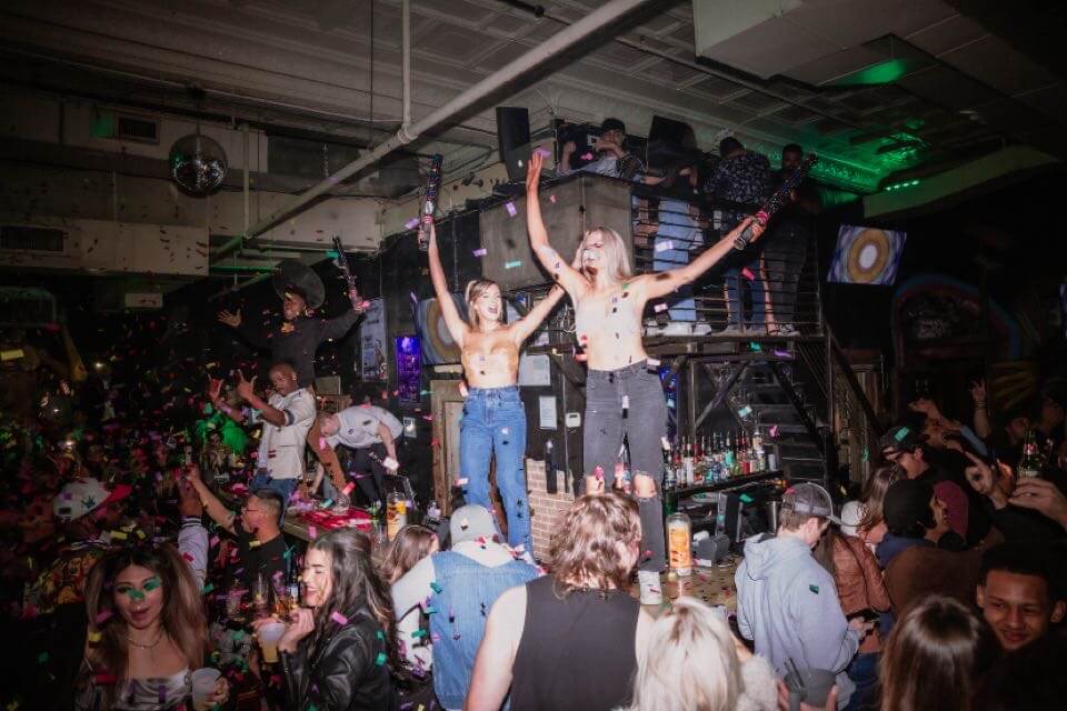 Girls and Guys dancing on bar